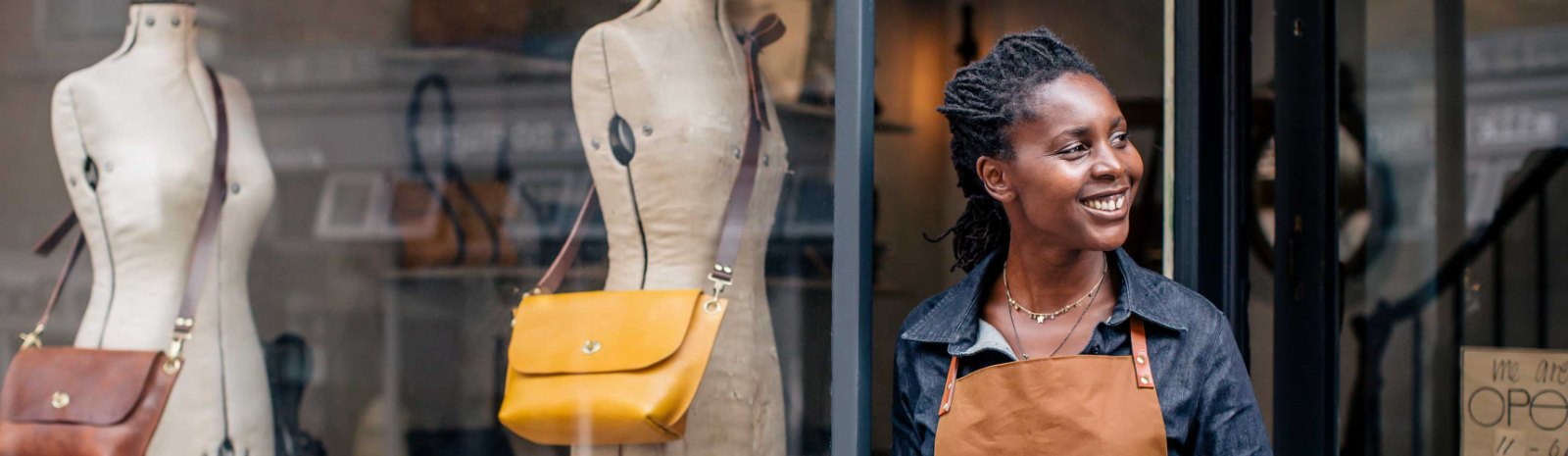 a woman standing outside her business